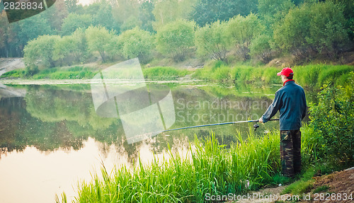 Image of Fisherman Casting On Calm River
