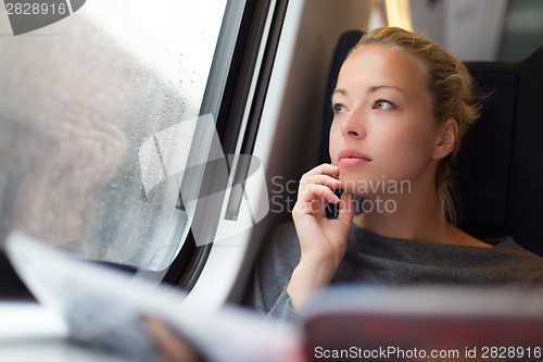 Image of Lady traveling by train.