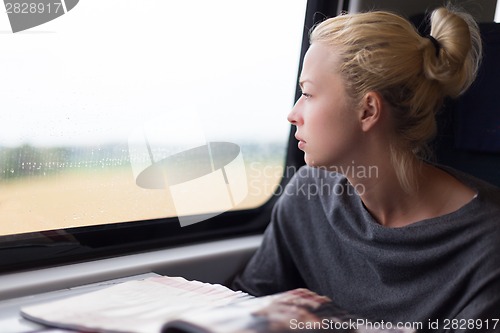 Image of Lady traveling by train.