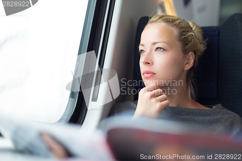 Image of Lady traveling by train.