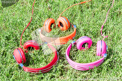 Image of Three varicolored vibrant colorful headphones