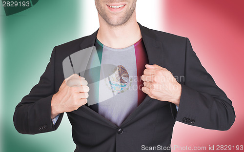 Image of Businessman opening suit to reveal shirt with flag