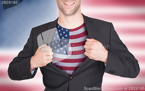 Image of Businessman opening suit to reveal shirt with flag