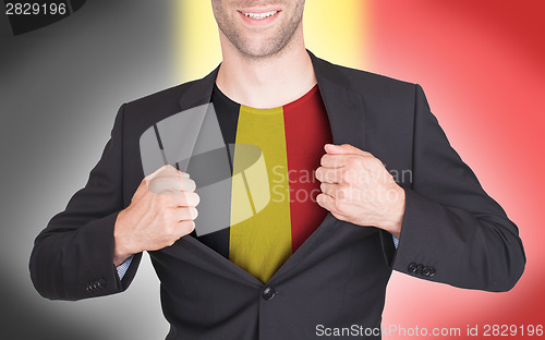 Image of Businessman opening suit to reveal shirt with flag