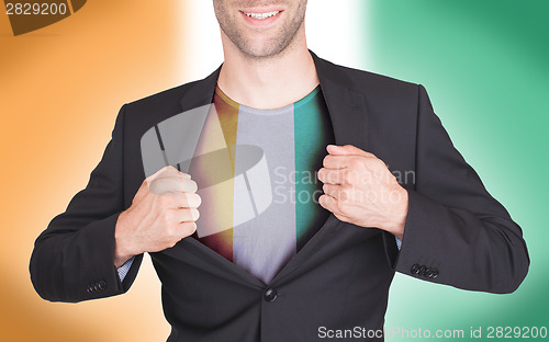 Image of Businessman opening suit to reveal shirt with flag