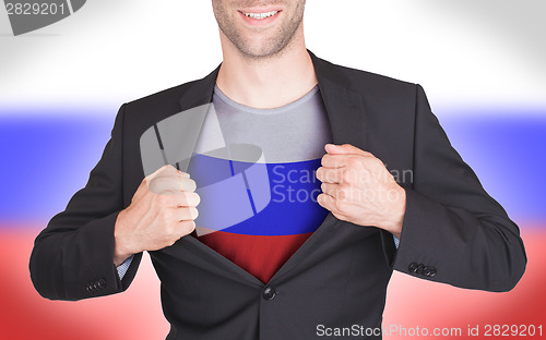 Image of Businessman opening suit to reveal shirt with flag