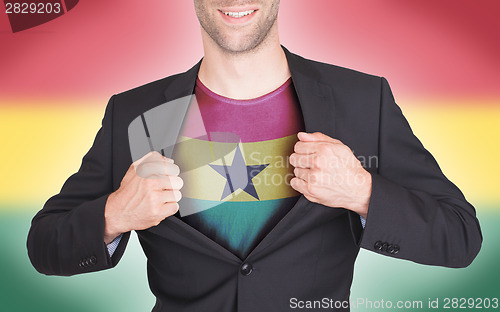 Image of Businessman opening suit to reveal shirt with flag