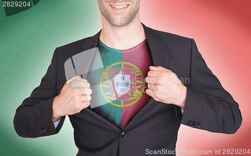 Image of Businessman opening suit to reveal shirt with flag