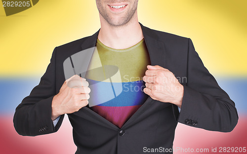 Image of Businessman opening suit to reveal shirt with flag