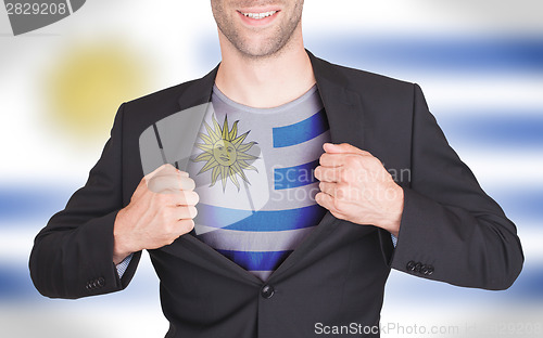 Image of Businessman opening suit to reveal shirt with flag