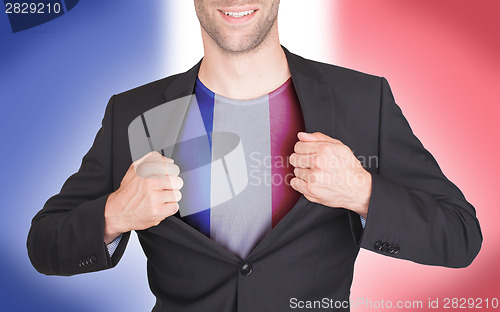 Image of Businessman opening suit to reveal shirt with flag