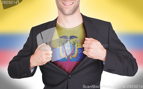 Image of Businessman opening suit to reveal shirt with flag