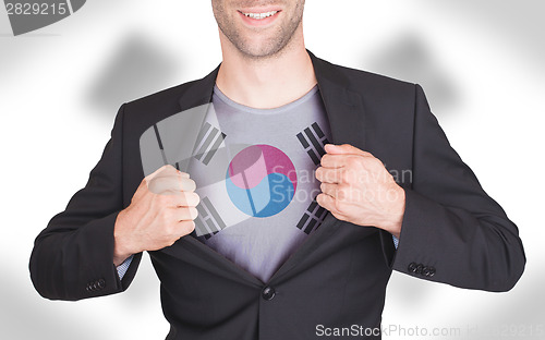 Image of Businessman opening suit to reveal shirt with flag