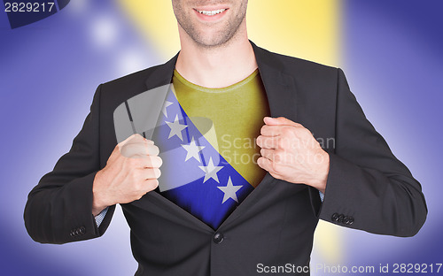 Image of Businessman opening suit to reveal shirt with flag