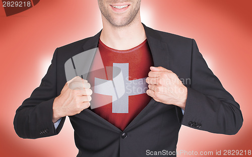 Image of Businessman opening suit to reveal shirt with flag