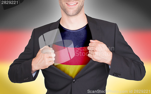 Image of Businessman opening suit to reveal shirt with flag