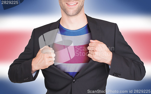 Image of Businessman opening suit to reveal shirt with flag