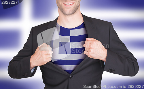 Image of Businessman opening suit to reveal shirt with flag