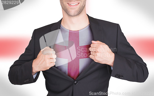 Image of Businessman opening suit to reveal shirt with flag