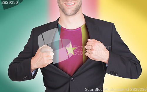 Image of Businessman opening suit to reveal shirt with flag