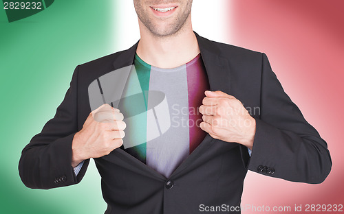 Image of Businessman opening suit to reveal shirt with flag