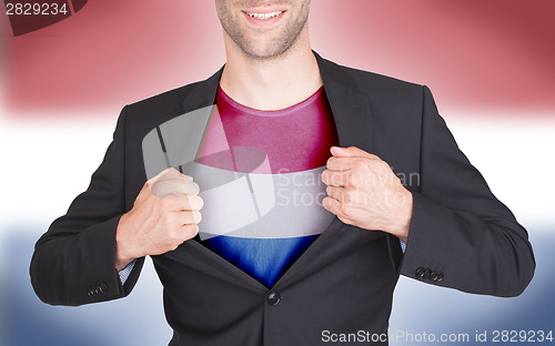 Image of Businessman opening suit to reveal shirt with flag