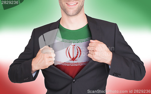 Image of Businessman opening suit to reveal shirt with flag