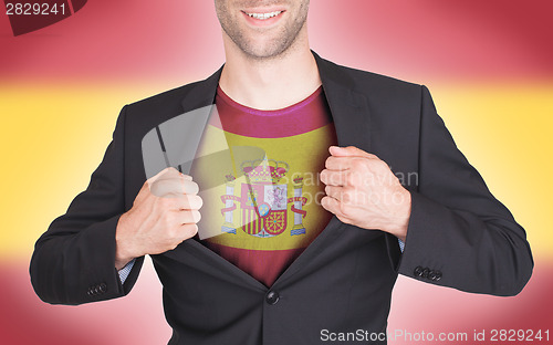 Image of Businessman opening suit to reveal shirt with flag