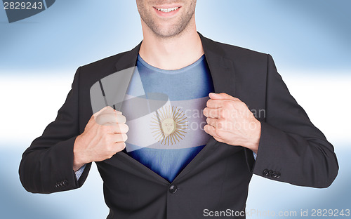 Image of Businessman opening suit to reveal shirt with flag