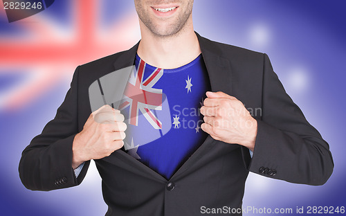 Image of Businessman opening suit to reveal shirt with flag