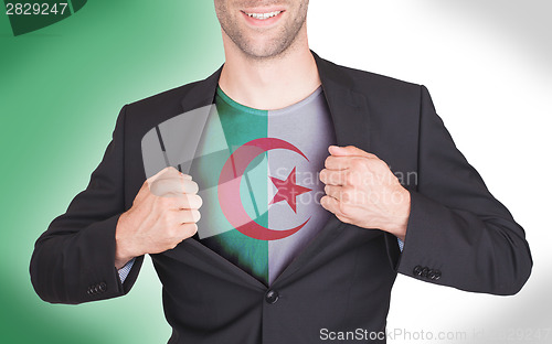 Image of Businessman opening suit to reveal shirt with flag