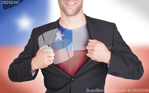 Image of Businessman opening suit to reveal shirt with flag