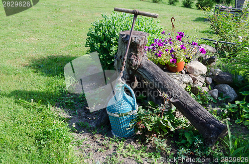 Image of wine bottle wrapped blue twig and stylized opener  