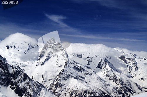 Image of Snowy mountains and blue sky with clouds