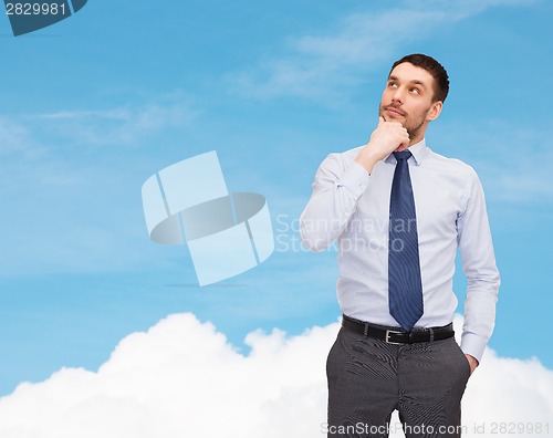 Image of handsome businessman looking up