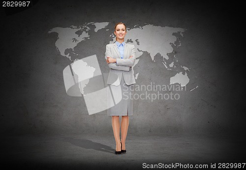 Image of young smiling businesswoman with crossed arms