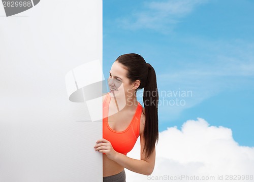 Image of teenage girl in sportswear with white board