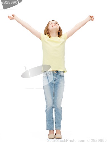 Image of smiling teenage girl with raised hands