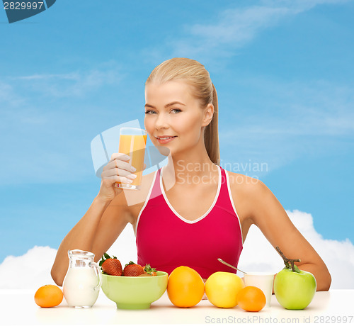 Image of smiling young woman eating healthy breakfast