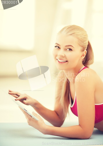 Image of woman lying on the floor with tablet pc