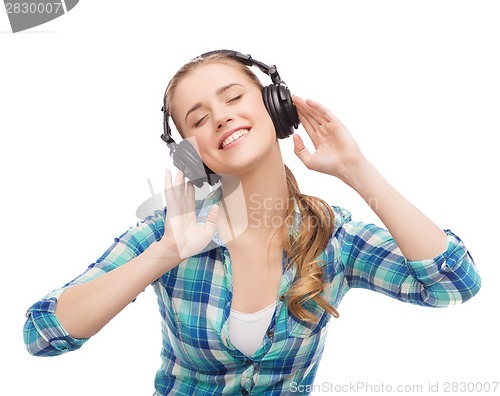 Image of young woman listening to music in headphones