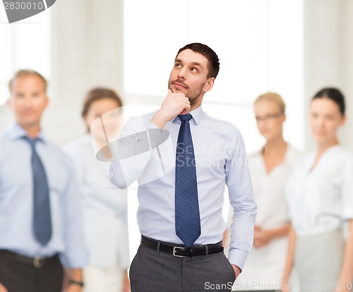 Image of handsome businessman looking up