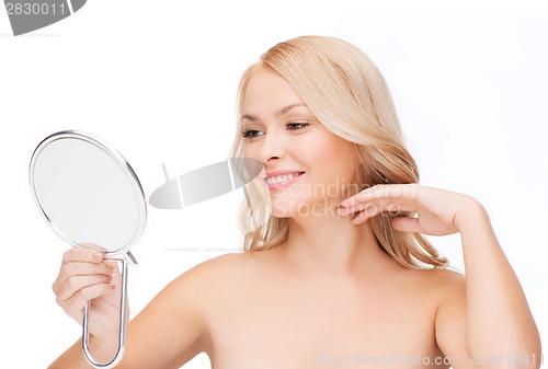 Image of smiling woman looking at mirror