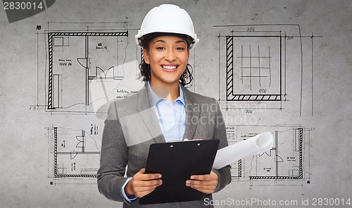 Image of businesswoman in white helmet with clipboard