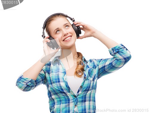 Image of young woman listening to music in headphones
