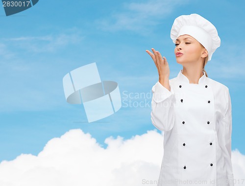 Image of smiling female chef showing delicious sign