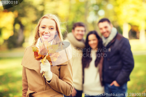 Image of group of friends having fun in autumn park
