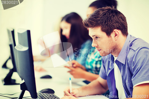 Image of student with computer studying at school