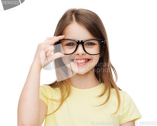 Image of smiling cute little girl in black eyeglasses