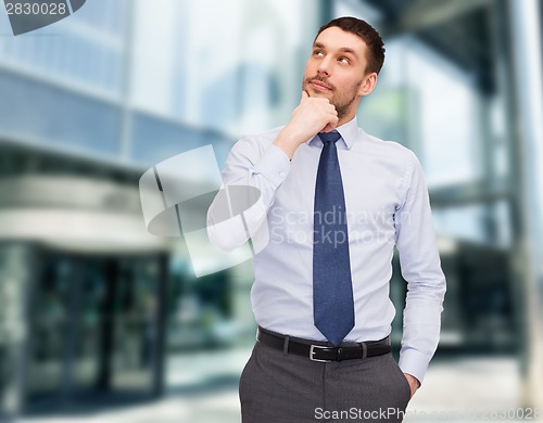 Image of handsome businessman looking up